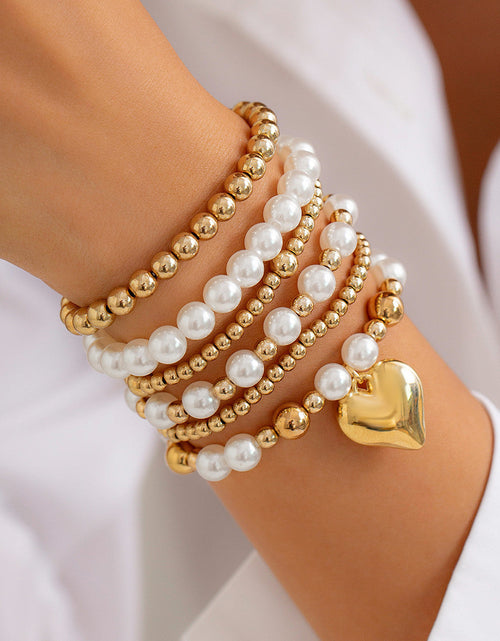 Load image into Gallery viewer, Minimally designed pearl bead bracelet with fashion sense and heart-shaped hollow Bracelet set
