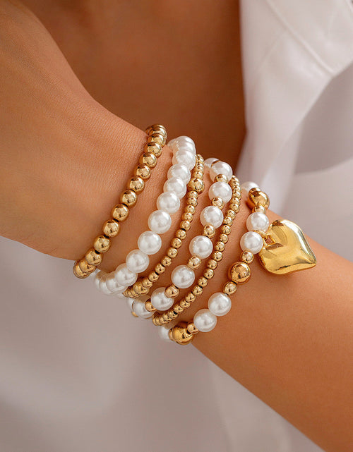 Load image into Gallery viewer, Minimally designed pearl bead bracelet with fashion sense and heart-shaped hollow Bracelet set
