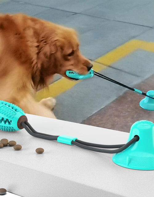 Load image into Gallery viewer, Pet Life ® 'Grip N' Play' Treat Dispensing Football Shaped Suction Cup Dog Toy
