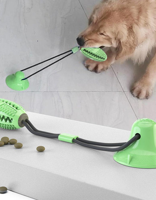 Load image into Gallery viewer, Pet Life ® 'Grip N' Play' Treat Dispensing Football Shaped Suction Cup Dog Toy

